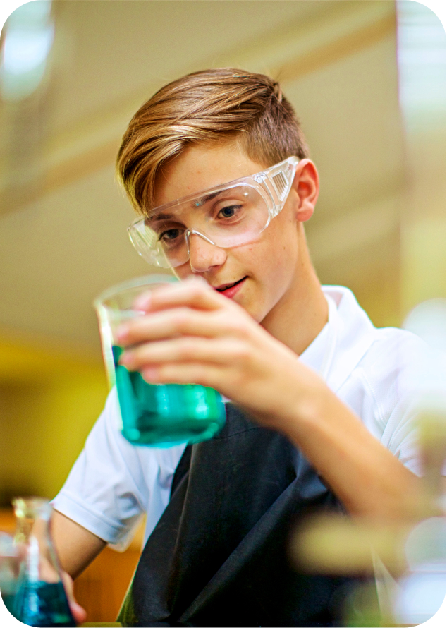 student holding chemical in cup